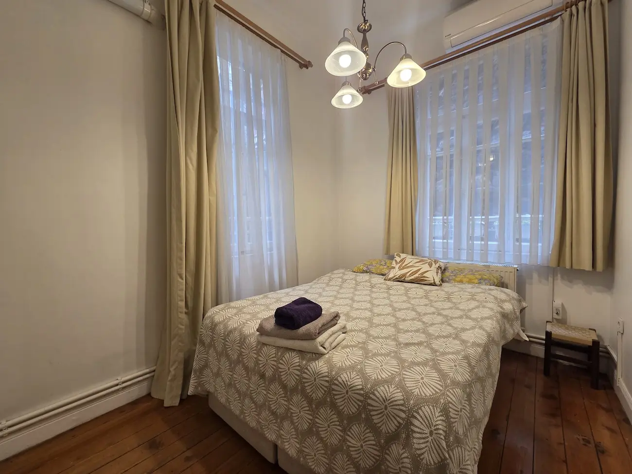 Cozy bedroom design with modern furniture and warm lighting in a Galata apartment, Istanbul.