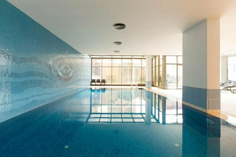 Modern indoor swimming pool with luxury facilities and elegant lighting in a Beyoğlu residential complex, Istanbul.
