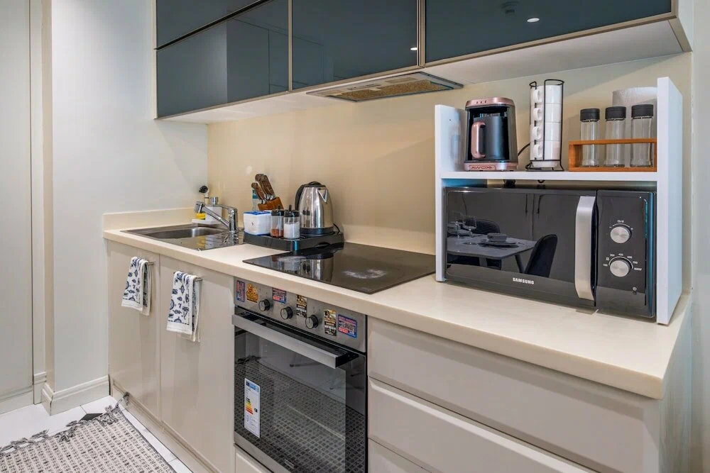 Modern sleek kitchen island with high-end appliances and smart home features in a Beyoğlu apartment, Istanbul.